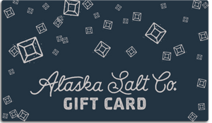 digital mockup image of a dark blue gift card with white salt crystal snowflakes. Text: Alaska Salt Co. Gift Card
